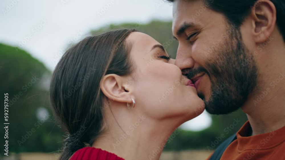 Cheerful couple kissing nature closeup. Portrait of affectionate lovers on date. Cheerful couple kissing nature closeup. Portrait of affectionate lovers on date.