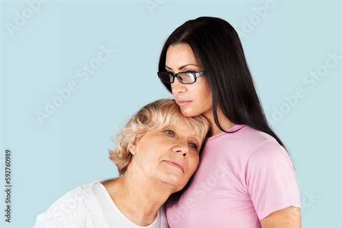 Cheerful smiling old mom with adult daughter