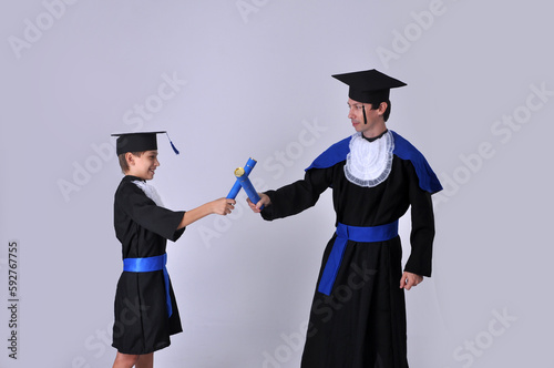 formatura pai e filho iguais com roupas de formandos acadêmicos graduados   photo