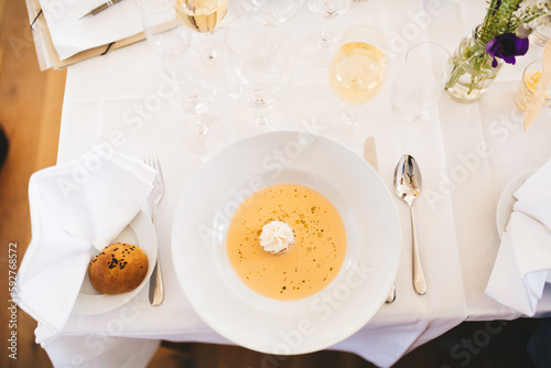 Top view of a table setting with a plate of soup.