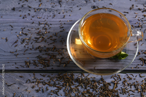 Cup of hot green tea on blu...