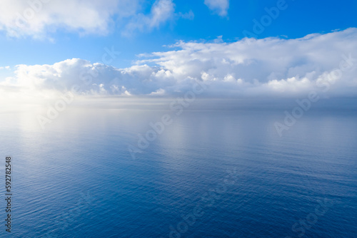 Sea and water, beautiful calm landscape of clouds reflecting in the water, view from mirador del malcon on Gran Canaria.