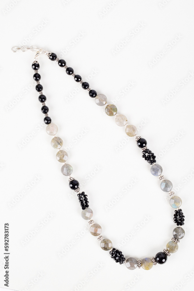 Top view of black bead necklace isolated on white background, semi precious jewelery Top view of black bead necklace isolated on white background, semi precious jewelery