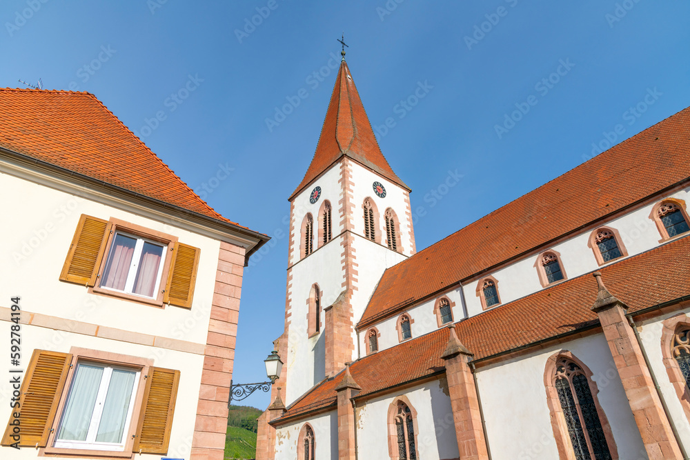 The exterior and tower of the Eglise Saint-Martin, the historic church in the Alsatian town of Ammerschwihr, France, one of the smaller towns along the Wine Route of the Alsace region.


