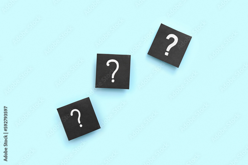 Papers with question marks on blue background Papers with question marks on blue background
