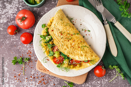 Photography Tasty omelet with vegetables on grey grunge background