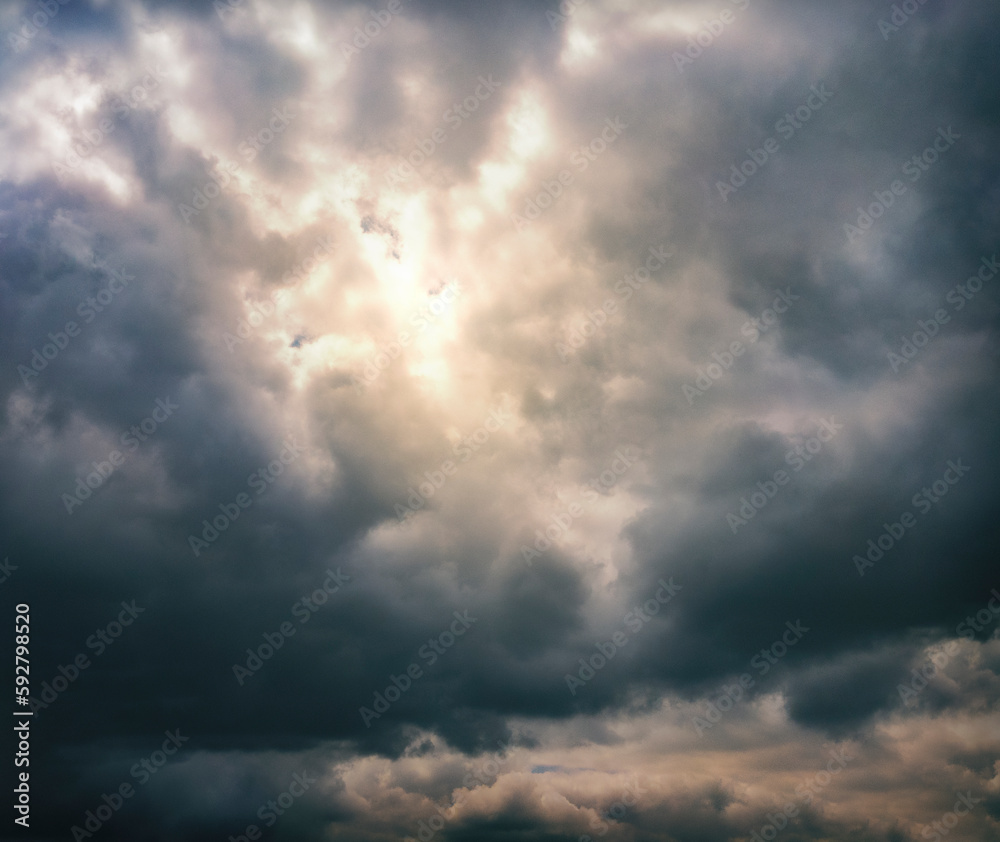 sunlight peeking through a dramatic cloudy sky