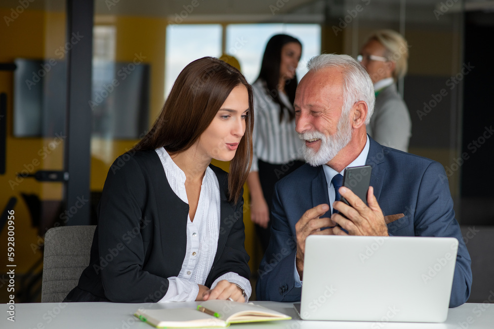 Fototapeta premium Mature businessman leader mentor talking to diverse colleagues team listening to caucasian ceo.