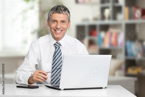 Happy young businessman working inside office