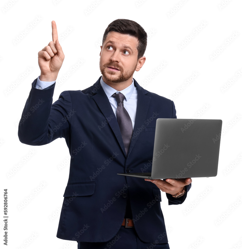 Handsome bearded businessman in suit with laptop pointing at something on white background Handsome bearded businessman in suit with laptop pointing at something on white background