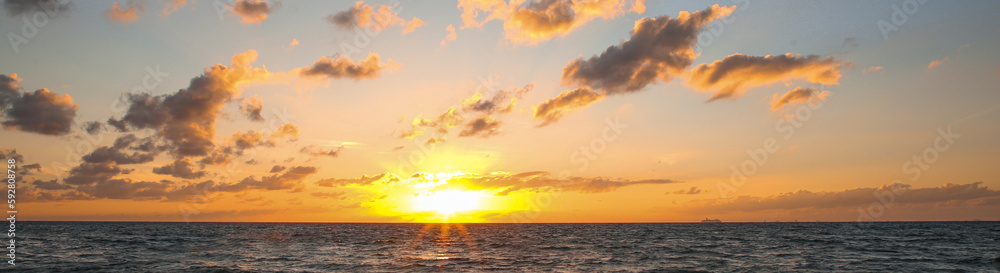 Beautiful sky with sun over sea at sunset, banner design