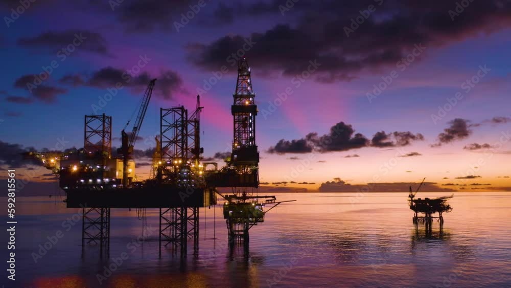Aerial view of silhouette offshore jack up drilling rig during sunset - oil and gas industry
Aerial view of silhouette offshore jack up drilling rig during sunset - oil and gas industry