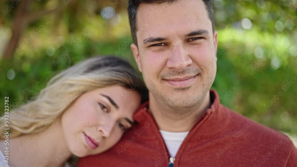 Man and woman couple smiling confident standing together at park Man and woman couple smiling confident standing together at park