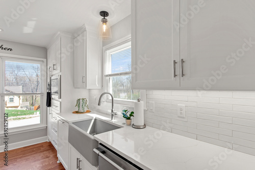 Modern Minimalism Kitchen Design with White Tiles, Quartz Countertops, and Stainless Steel Appliances