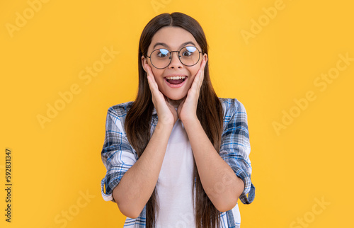 amazed teenager girl on background. photo of teenager girl with long hair wearing glasses.