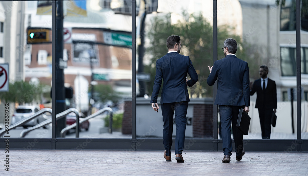 back view of business men coworker in the street, banner. photo of business men coworker back view of business men coworker in the street, banner. photo of business men coworker