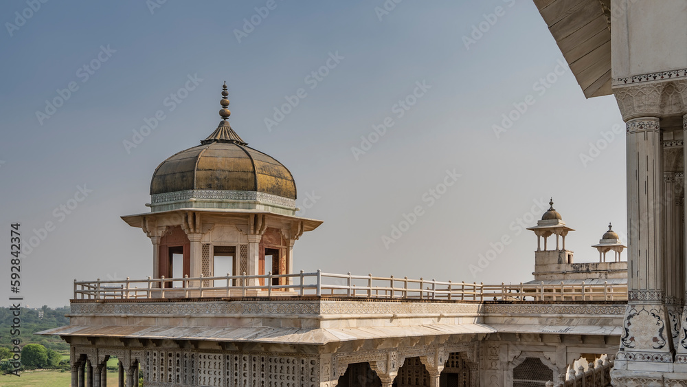 Musamman Burj at the Red Fort Palace. Towers with domes and spires against the blue sky. A carved marble colonnade is visible. India. Agra.