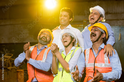 Group of Indian engineers laughing having fun together in industrial factory. team work. skill india,