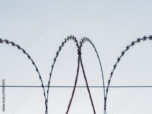 Barbed wire fences around the prison prevent prisoners from escaping.
