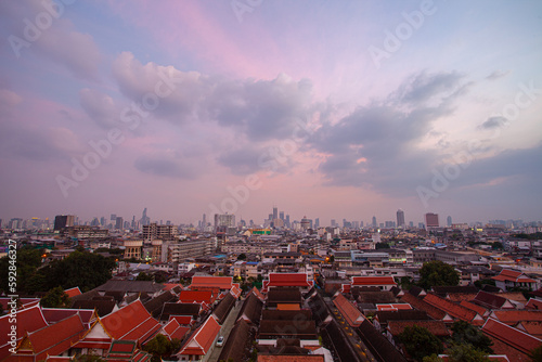 The colorful sky over Bangkok city center in the evening. amazing red sky at sunset. Temples and buildings in Bangkok background.