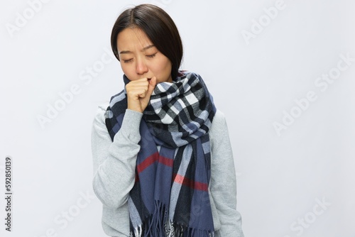 Asian woman cold flu raised hands from headache and toothache with fever sick from covid 19 virus in checkered scarf on white background, copy space