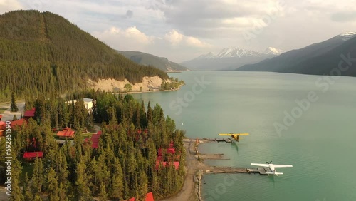 Aerial view, bush planes are parked at the lodge on the lake shore along the Alaska Highway. Travel, adventure, journey concept. Northern Rocky Mountains, Muncho Lake Park, British Columbia, Canada photo