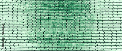 Vivid backdrop with old brick wall in green tones. Minimal fragment of brickwall close-up. Minimalist monochrome color background with dirty wall of green bricks close up. Simple wall texture.
