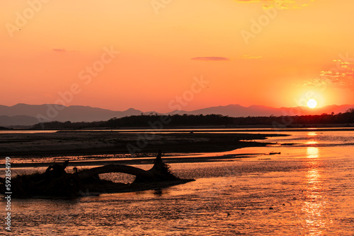 Sunset over Rapti River on the periphery of Chitwan National Park in Nepal photo