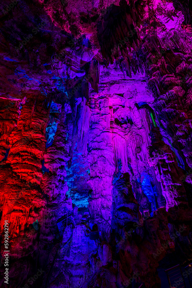 Illuminated natural underground rock formations inside St. Michaels cave in Gibraltar, UK