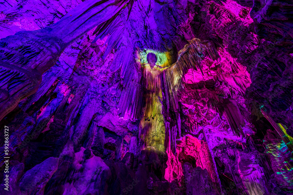 Illuminated natural underground rock formations inside St. Michaels cave in Gibraltar, UK