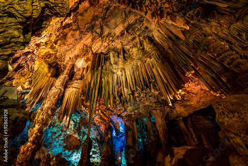 Illuminated natural underground rock formations inside St. Michaels cave in Gibraltar, UK