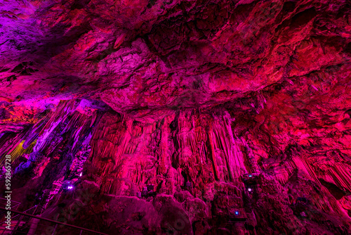 Illuminated natural underground rock formations inside St. Michaels cave in Gibraltar, UK