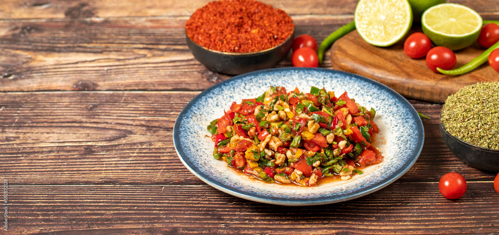Gavurdagi salad. Walnut salad on wood background. Healthy salad prepared with tomatoes, peppers, cucumbers, onions, pomegranate syrup, olive oil and walnuts. Top view. Empty space for text. Copy space Gavurdagi salad. Walnut salad on wood background. Healthy salad prepared with tomatoes, peppers, cucumbers, onions, pomegranate syrup, olive oil and walnuts. Top view. Empty space for text. Copy space