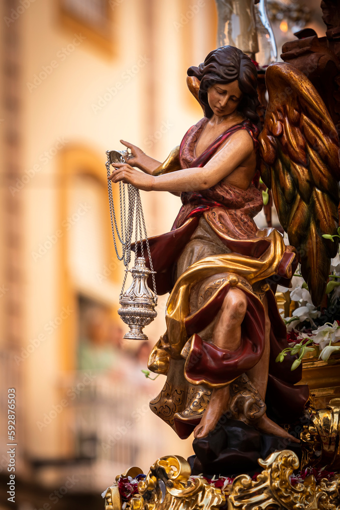 Polychromed figure in a golden throne during a procession of holy week, Seville, Spain