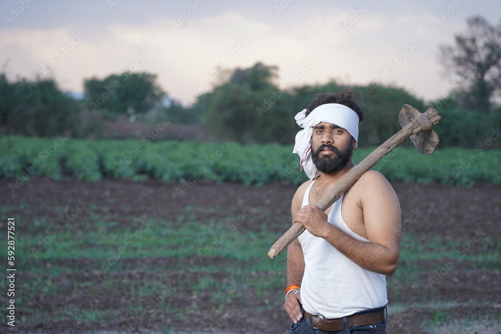Young Indian farmer at agriculture field.      
