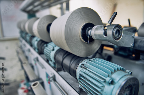 Fototapeta Naklejka Na Ścianę i Meble -  An Old industrial stainless steel metal cotton weaving spindle reel, machine weaving cotton for the fashion and textiles industry. Yarn weave traditional textile fabric manufacturing for clothing.