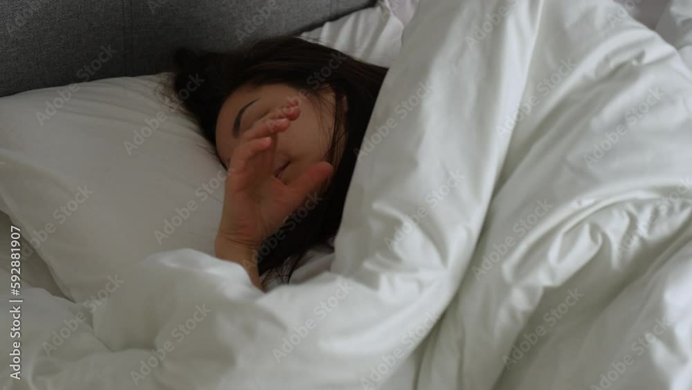 Young woman sleeping in white bed on pillow Young woman sleeping in white bed on pillow
