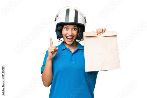 Young Argentinian woman taking a bag of takeaway food over isolated background pointing up a great idea