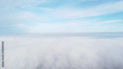 Sky clouds fog. Aerial drone view of blue sky and white clouds. View of fog from above and blue sky with clouds. View from above. Fog movement over city.Abstract natural background. Nature backdrop.