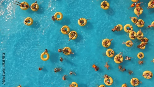 Aerial view of people relaxing in swimming pool 