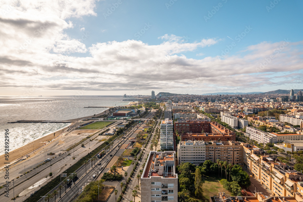 Top view stunning view of Diagonal Mar district in Barcelona with modern urban amenities and developed infrastructure on a sunny warm summer day. The concept of a modern European coastal city