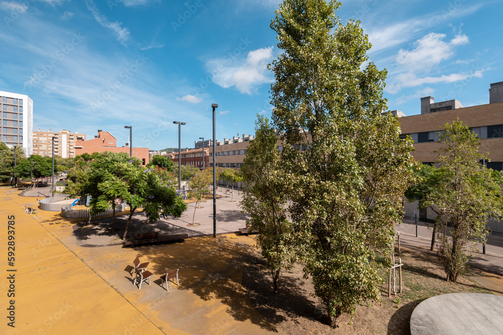 Sunny courtyard and urban space between new buildings in a fashionable area of Spain on a summer day. Comfortable landscaping concept. Copyspace Sunny courtyard and urban space between new buildings in a fashionable area of Spain on a summer day. Comfortable landscaping concept. Copyspace