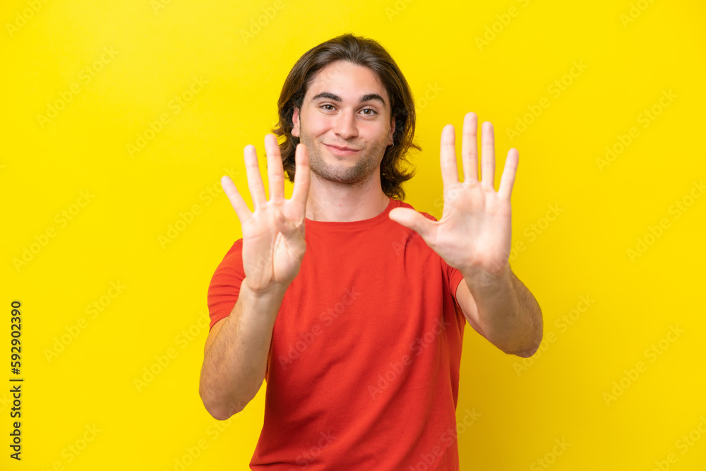 Caucasian handsome man isolated on yellow background counting nine with fingers Caucasian handsome man isolated on yellow background counting nine with fingers