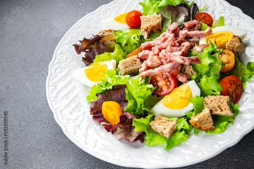 Vosges green salad, egg, bacon salad, crouton, lettuce, salad dressing vinaigrette Lorraine cuisine meal food snack on the table copy space food background rustic top view