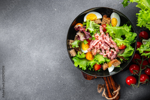Vosges green salad, egg, bacon salad, crouton, lettuce, salad dressing vinaigrette Lorraine cuisine meal food snack on the table copy space food background rustic top view