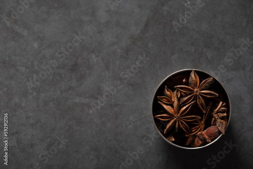 spice tin of star anise on dark marble background