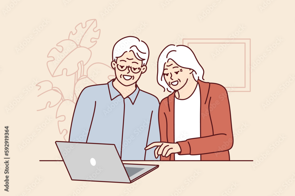 Elderly men and women are sitting at table with laptop learning how to handle modern technology and computer literacy. Elderly couple make video call to children using laptop with internet Elderly men and women are sitting at table with laptop learning how to handle modern technology and computer literacy. Elderly couple make video call to children using laptop with internet