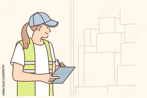 Warehouse manager woman doing inventory counting boxes in warehouse or truck and holding clipboard