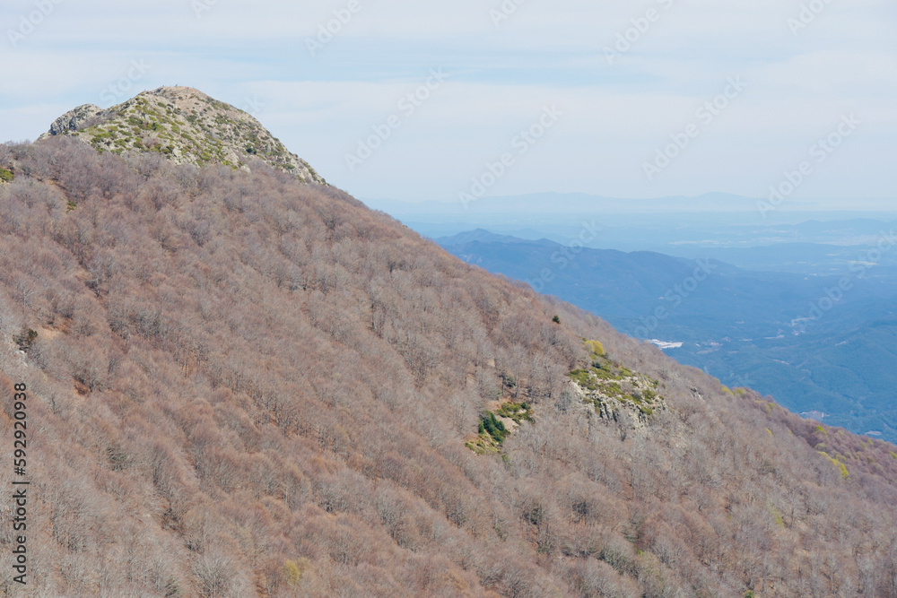 Hiking routes in the Montseny. Les Agudes peak. Hikers at the top of the mountain. Hiking routes in the Montseny. Les Agudes peak. Hikers at the top of the mountain.
