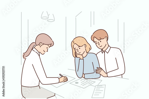 Married couple is consulting insurance agent or lawyer and drawing up marriage contract in office